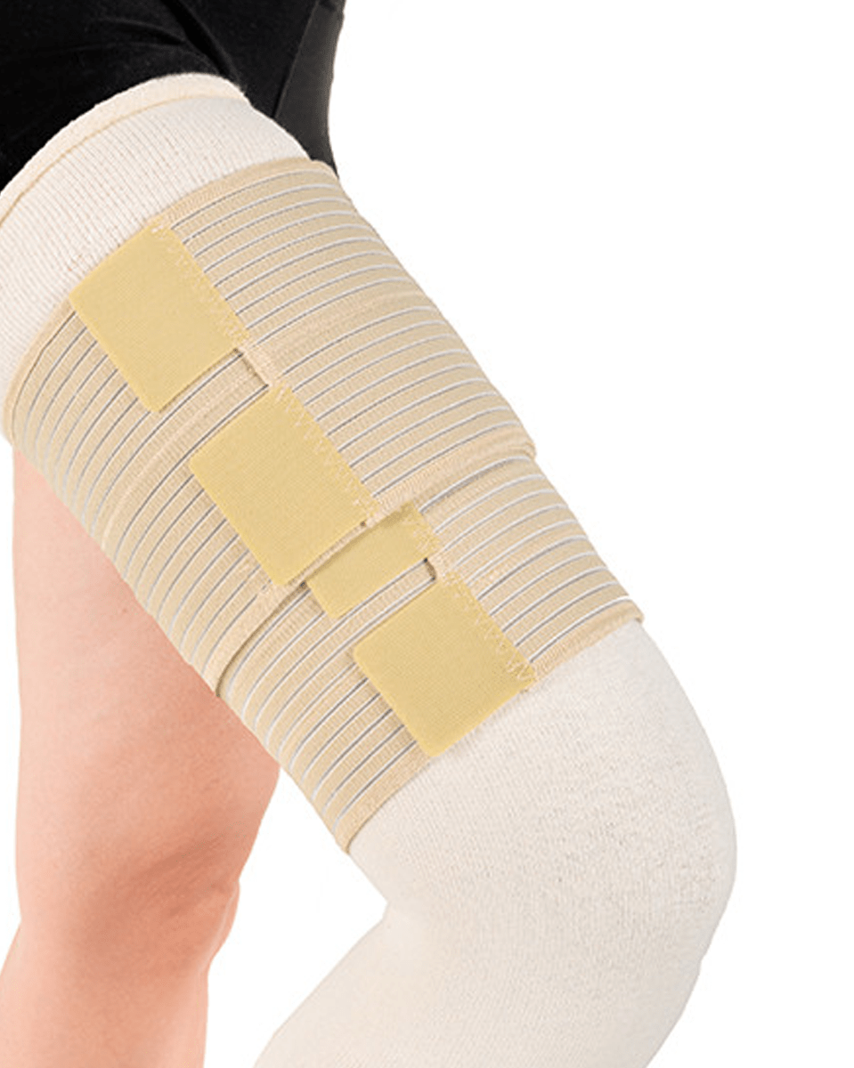 Beige knee brace on a person's leg against a white background
