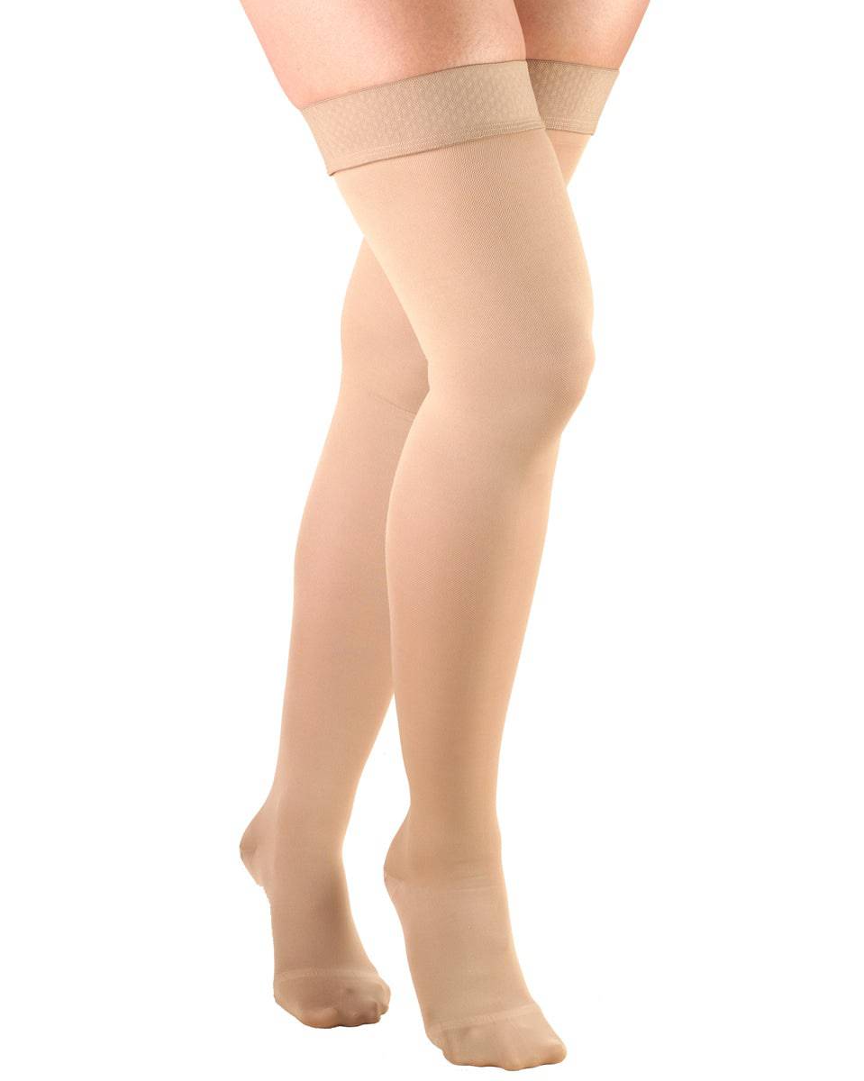 Beige knee-high socks worn by a person on a white background
