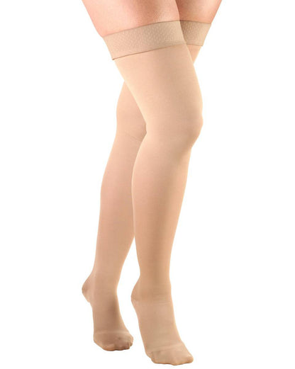 Beige knee-high socks worn by a person on a white background