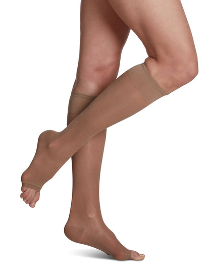 Beige knee-high socks worn by a person on a white background