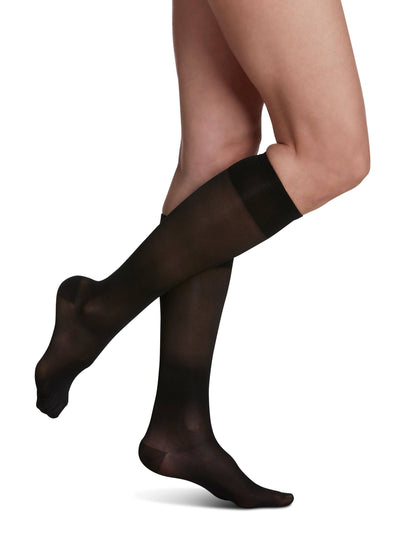 Black compression stockings worn by a person on a white background