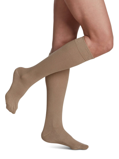 Khaki knee-high socks worn by a person on a white background