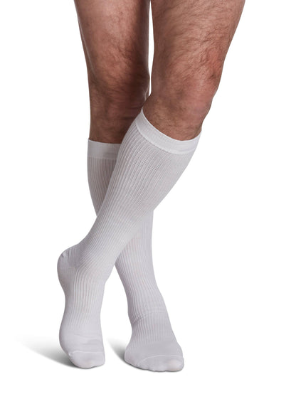 White knee-high socks worn by a person on a white background
