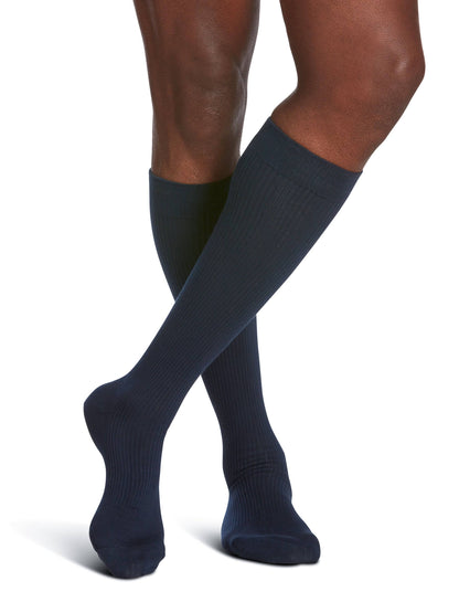 Navy blue knee-high socks worn by a person on a white background