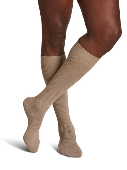 Brown knee-high socks worn by a person on a white background