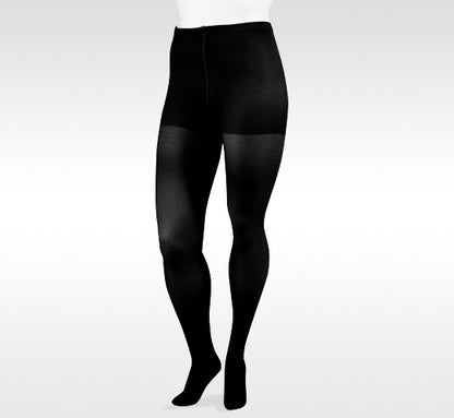 Black tights worn by a person on a white background in Juzo from compressionsale 