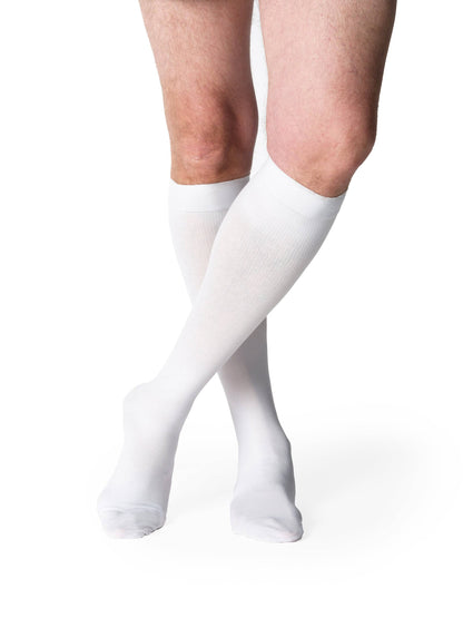 White knee-high socks worn by a person on a white background