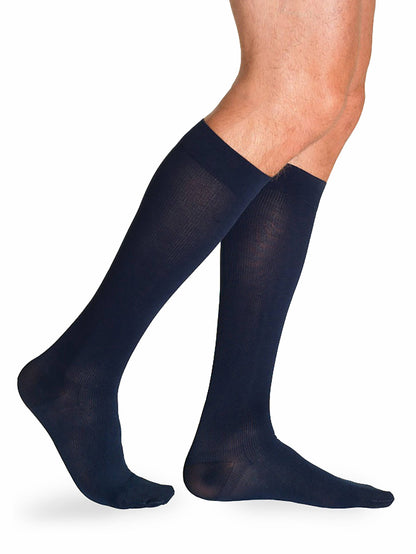 Navy Blue knee-high socks worn by a person on a white background