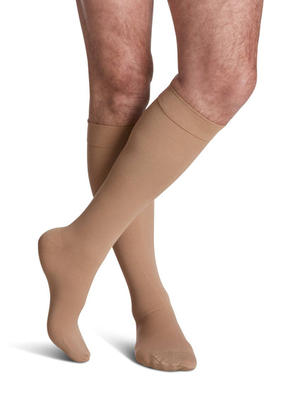 Light Begie knee-high socks worn by a person on a white background