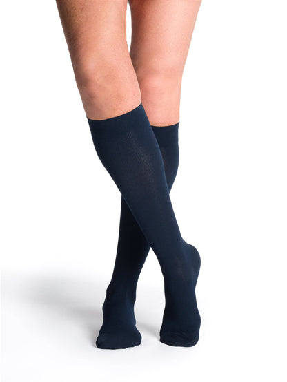 Navy knee-high socks worn by a person on a white background