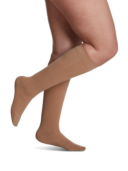 Begie knee-high socks worn by a person on a white background