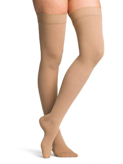 Beige knee-high socks on a white background