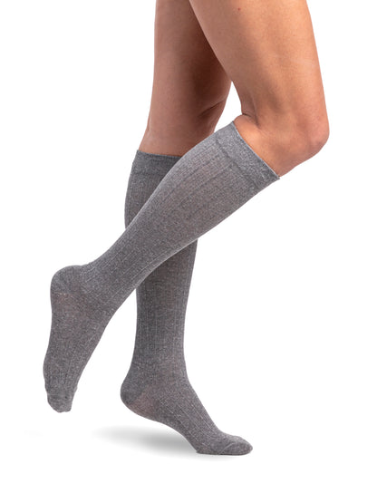 Knee-high socks worn by a person on a white background