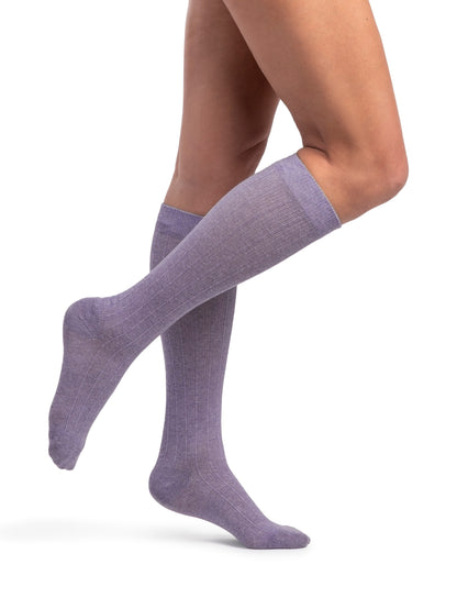 Knee-high socks worn by a person on a white background