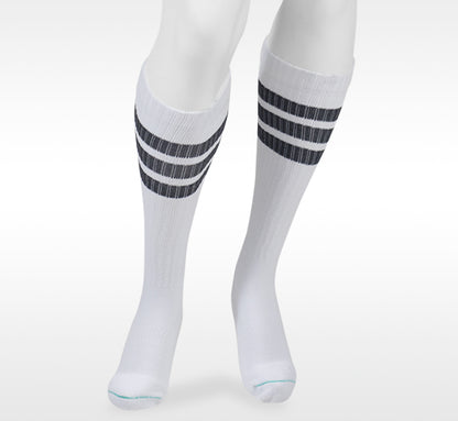 White knee-high socks with black stripes on a white background in Juzo from  Compressionsale