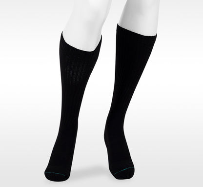 “Black knee-high socks worn on a white background. Discover the Juzo Compressionsale collection of compression hosiery designed for comfort, support, and everyday wear.