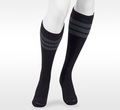 Black knee-high socks with gray stripes worn by a person on a white background in Juzo from compressionsale