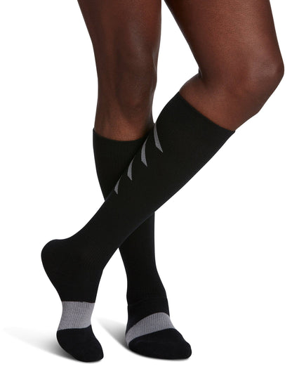 Blue knee-high socks worn by a person on a white background