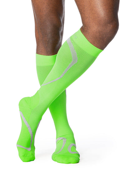 Lime compression socks with gray accents on a white background