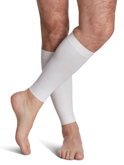 White compression sleeves on a person's legs against a white background