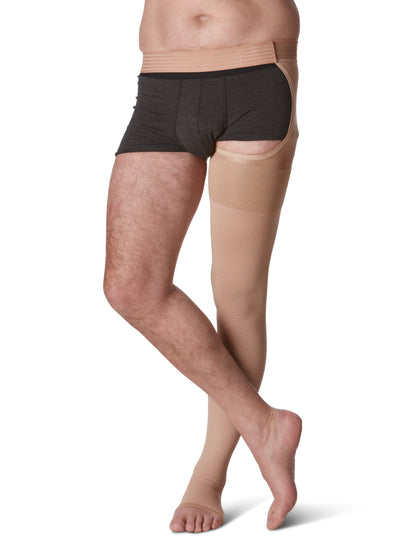 Person wearing black underwear with beige tights on a white background