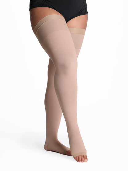 Beige compression stockings worn by a person on a white background