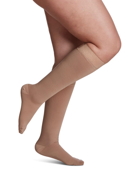 Beige tights worn by a person on a white background