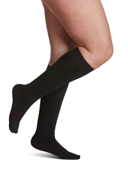 Black tights worn by a person on a white background