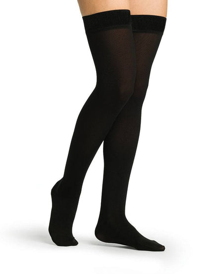 Black tights worn by a person on a white background