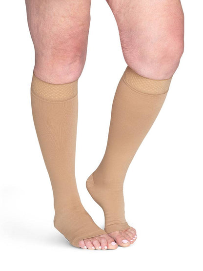 Begie knee-high socks worn by a person on a white background