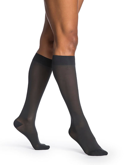 Navy sheer stockings worn by a person on a white background