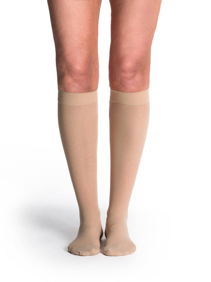 Honey knee-high socks worn by a person on a white background