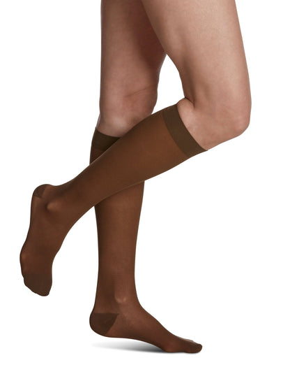 Mocha knee-high socks worn by a person on a white background
