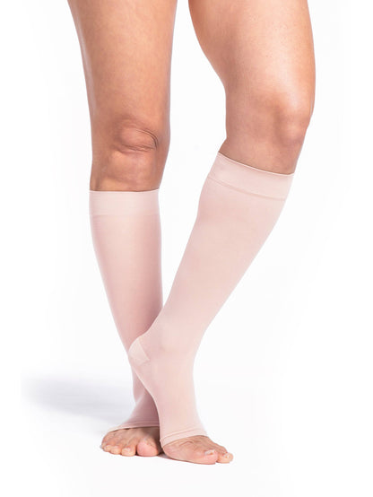 Warm Sand compression stockings being worn on a white background