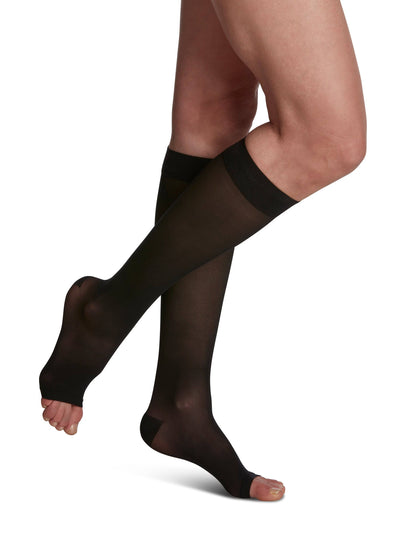 Black knee-high socks with navy tops on a white background