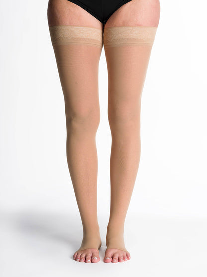 Golden sheer stockings with lace top on a white background