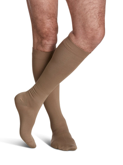 Beige knee-high socks worn by a person on a white background