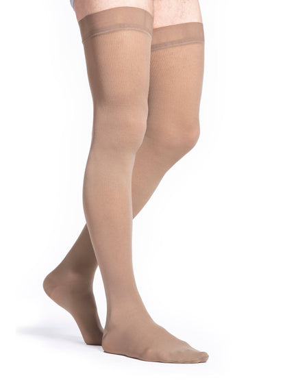 Beige sheer stockings worn by a person on a white background