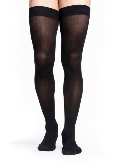 Black sheer stockings worn by a person on a white background