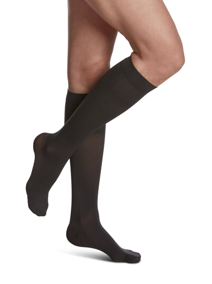Navy Blue knee-high socks worn by a person on a white background