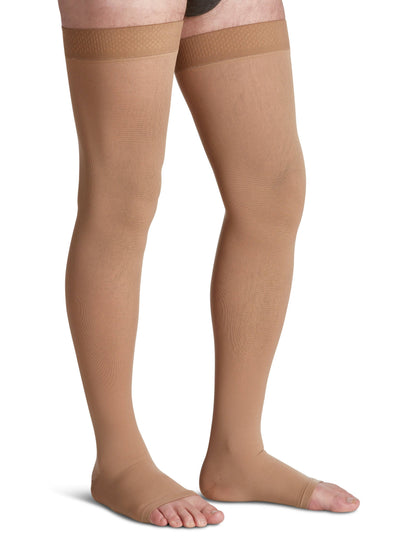 Beige compression stockings worn by a person on a white background