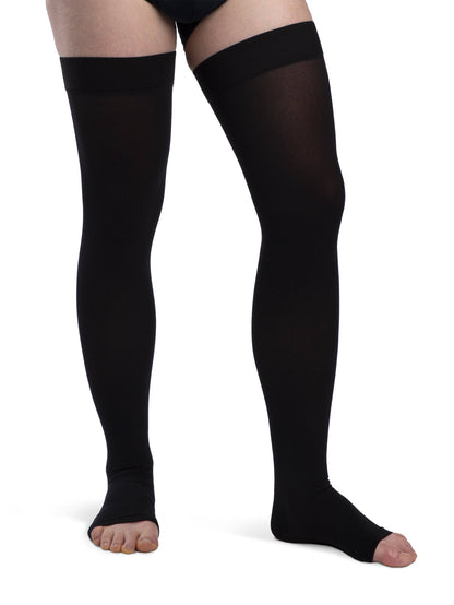 Black compression stockings worn by a person on a white background