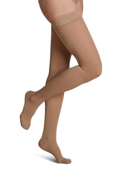 Golden sheer stockings with lace top on a white background
