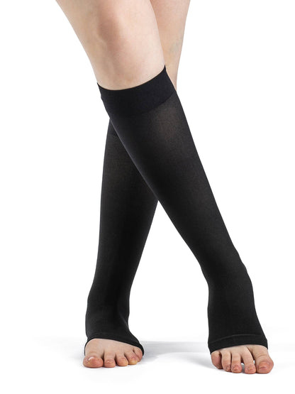 Black compression stockings worn by a person on a white background