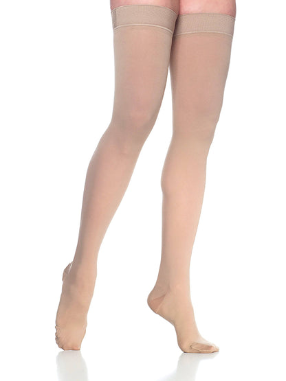 Beige knee-high socks worn by a person on a white background