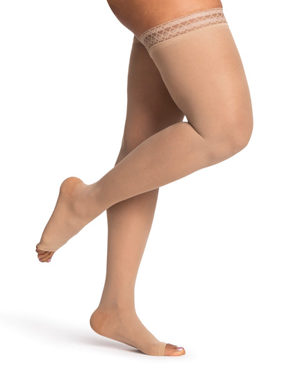 Beige sheer stockings worn by a model on a white background