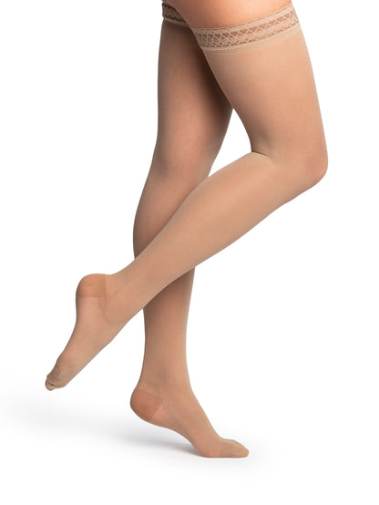 Beige sheer stockings with lace top on a white background