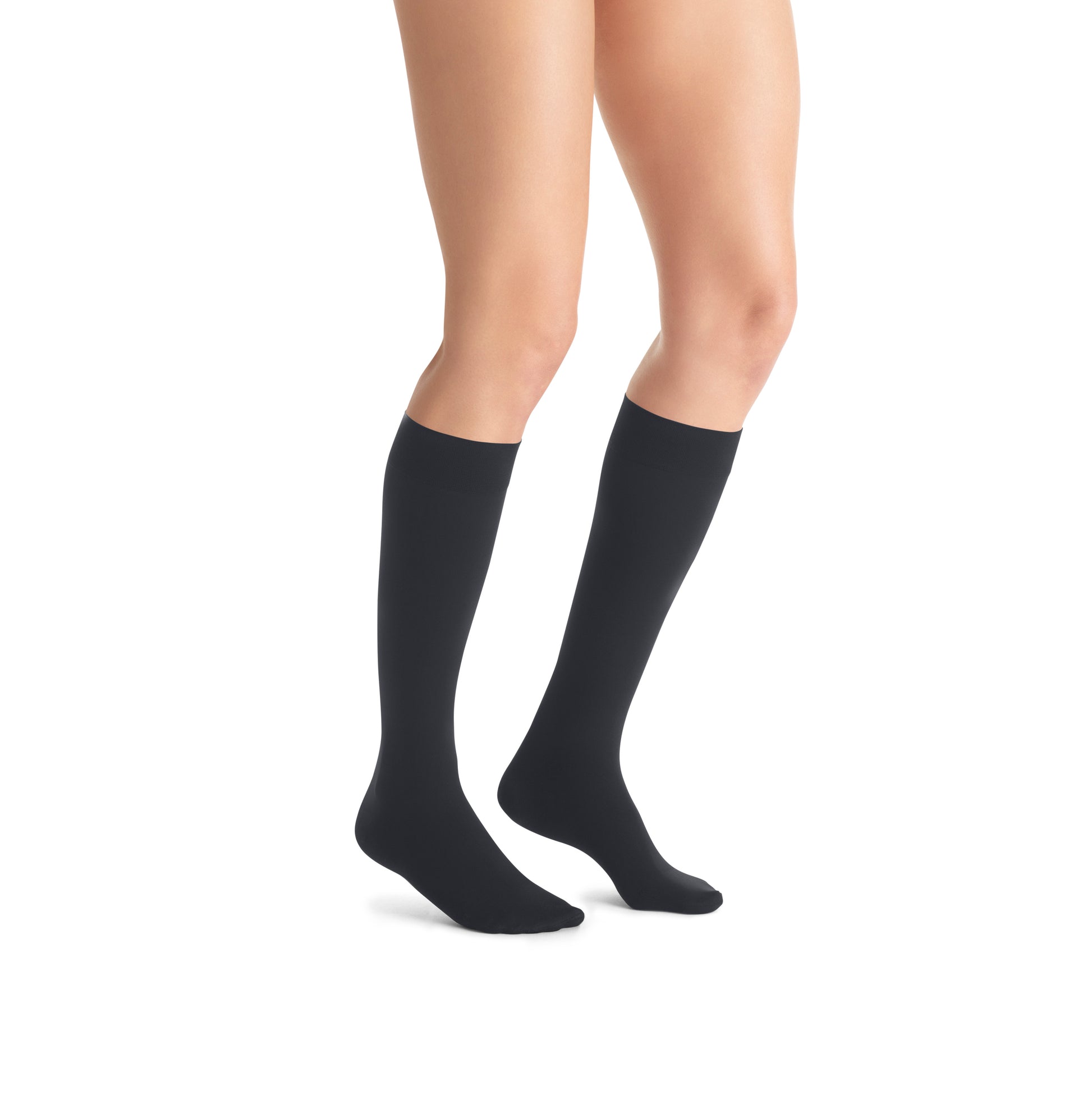 Black knee-high socks worn by a person on a white background