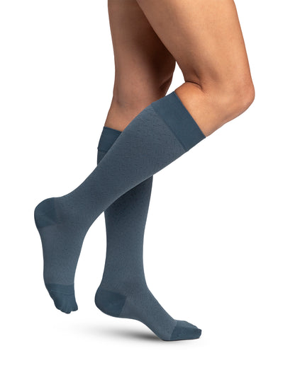 Knee-high blue socks worn by a person on a white background