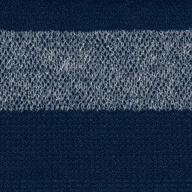 Close-up of a textured blue fabric with a white stripe at the top.